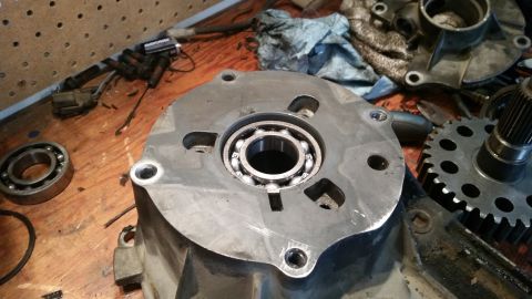 1985 Ford Bronco - A close-up view shows a bearing installed in a metal housing, likely part of a vehicle's drivetrain. Several other automotive parts, includ…