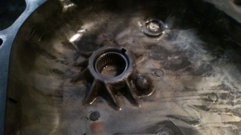 1985 Ford Bronco - A close-up view of the interior of a metal casing, likely part of a transmission or differential, showing a splined shaft housing with a st…