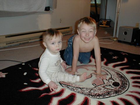 1983 Ford Bronco - Two young boys are playing on a rug indoors.