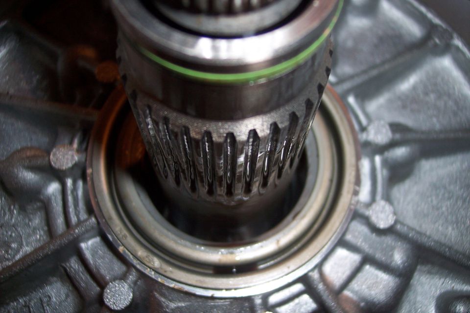 Close-up of a splined shaft with a green O-ring.