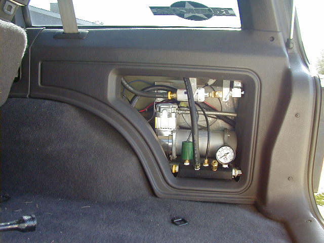 Interior view of an air compressor system installed in the cargo area of a vehicle