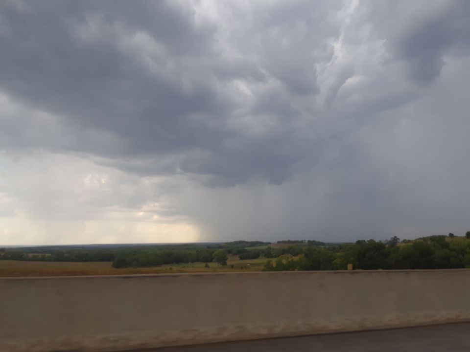 Stormy sky with rain falling over a rural landscape