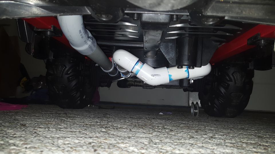 Underside of an ATV with PVC pipes attached to the frame
