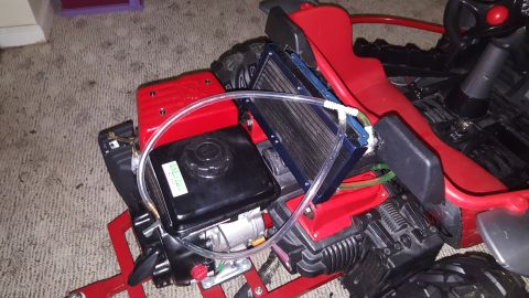 2007 Subaru Impreza - Modified go-kart engine assembly with a visible radiator and tubing.