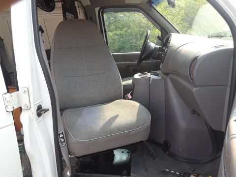 1999 Ford E250 - Interior view of a 1999 Ford E250 van, focusing on the driver's seat and dashboard area.
