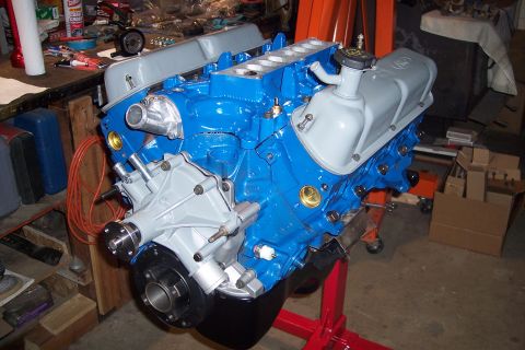 1995 Ford Bronco - A blue engine is mounted on a red stand, likely for rebuilding or display.