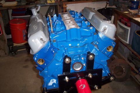 1995 Ford Bronco - Engine block assembly with silver valve covers and intake manifold, ready for installation.