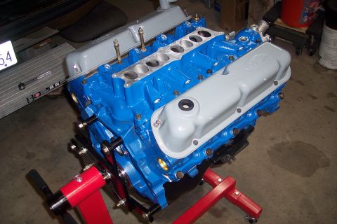 1995 Ford Bronco - A freshly painted Ford V8 engine sits on an engine stand, ready for installation.