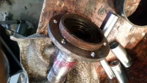 1985 Ford Bronco - A close-up shot shows a disassembled automotive part, likely a wheel hub assembly, with visible grease and rust. Several metal sockets are…