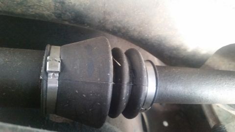 1985 Ford Bronco - A close-up view shows a black rubber CV boot with metal clamps on a vehicle's driveshaft. The boot is pleated and appears to be in good con…