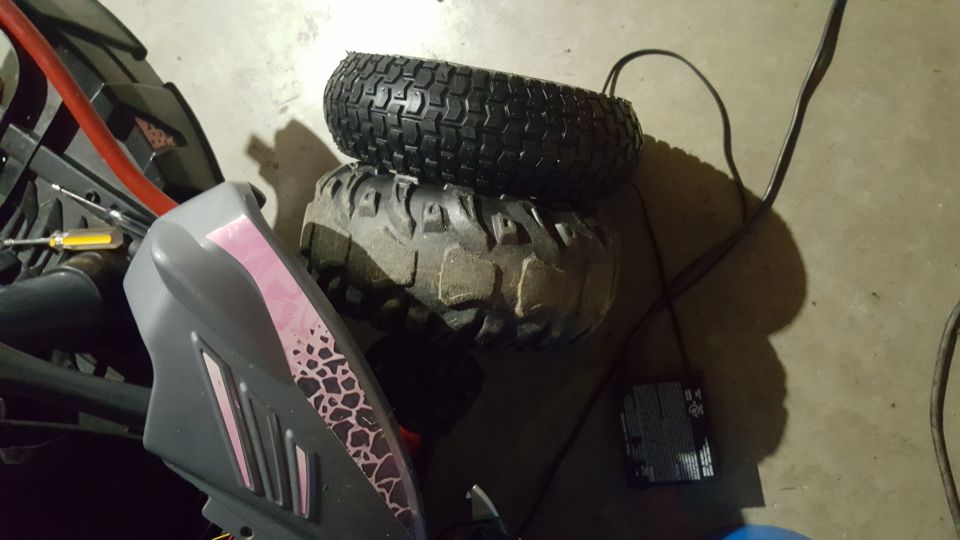 Two off-road tires stacked, with a power cord and battery charger.