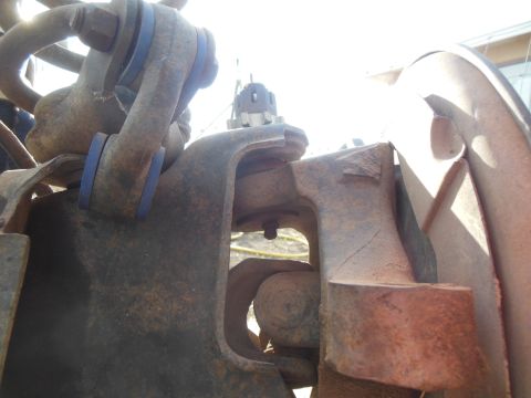 1984 Ford Bronco - A close-up, low-angle shot of rusty suspension components on a vehicle, featuring blue polyurethane bushings and heavy-duty metal brackets.…
