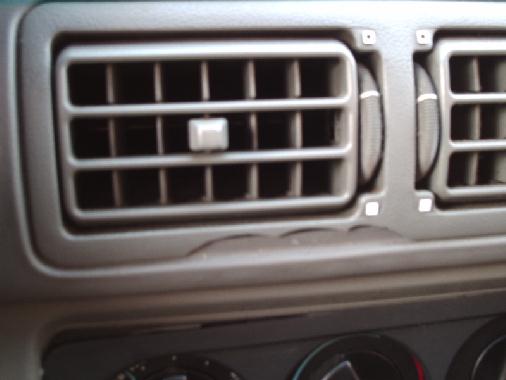Center dash air vents, dual outlets with adjustable louvers in gray plastic trim