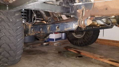 1996 Ford Bronco - The underside of a vehicle, likely a 1996 Ford Bronco, is shown with a focus on the suspension and frame components. Visible parts include…