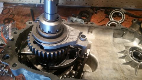 1985 Ford Bronco - A close-up view shows the internal components of a Ford Bronco transfer case, including gears, shafts, and bearings, disassembled on a wood…