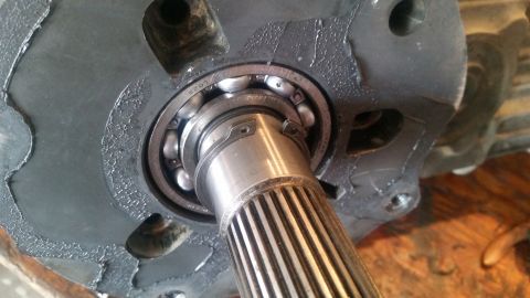 1985 Ford Bronco - A close-up view of a splined shaft and bearing assembly, likely from a vehicle's drivetrain. The bearing is partially visible, showing nume…