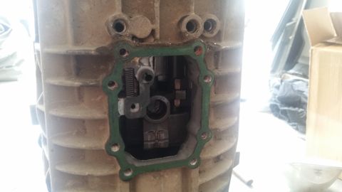 1985 Ford Bronco - A close-up view of the internal mechanism of a transmission, with a green gasket visible around an opening. The transmission housing is mad…