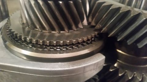 1985 Ford Bronco - A close-up view shows the helical gears of a transmission or differential. The metallic teeth of the gears are clearly visible, with one se…