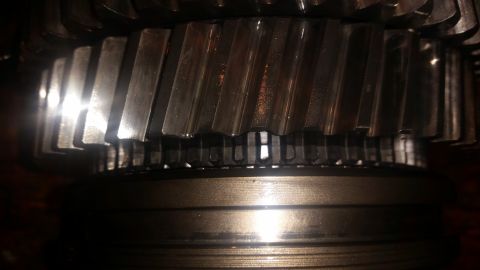 1985 Ford Bronco - A close-up shot shows the helical gears of a transmission or differential. The metal gears have a polished finish with visible machining ma…