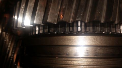 1985 Ford Bronco - Close-up view of internal gears, likely from a transmission or transfer case. The metal teeth show signs of wear and possibly damage.
