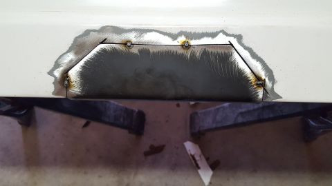 1995 Ford Bronco - The metal underneath is prepped (no pic) and a new piece of sheetmetal cut. Tacked it into place with the MIG. If you're going to do this,…