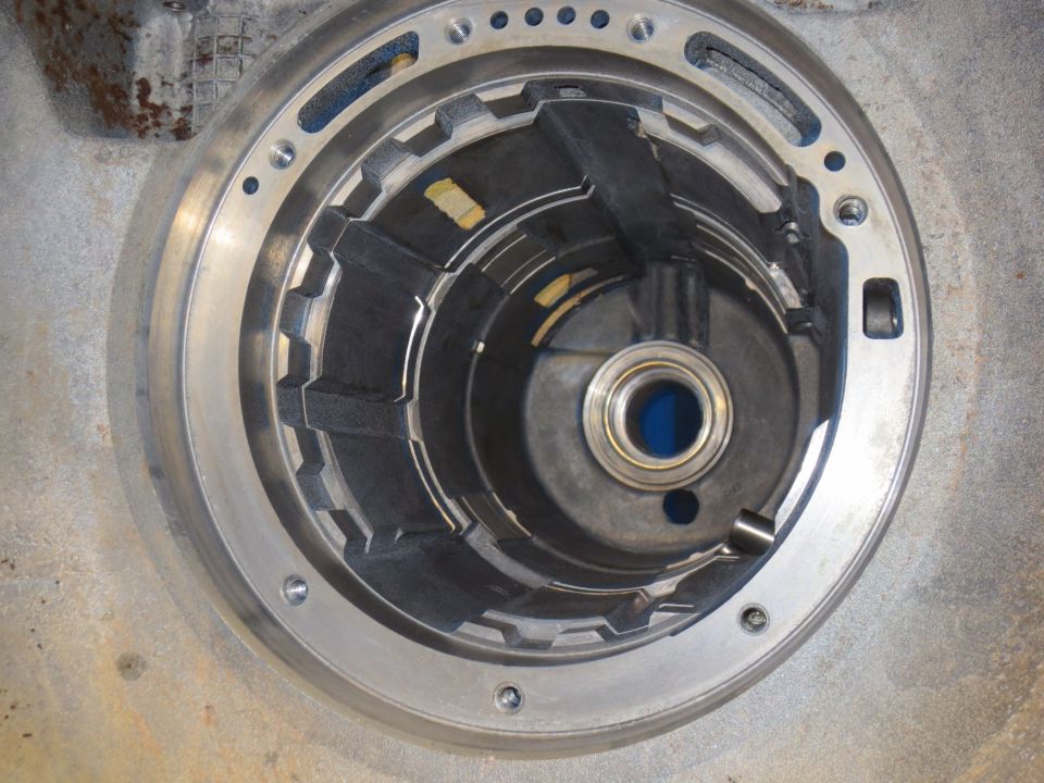 Internal view of a transmission torque converter with fins and a central bearing.