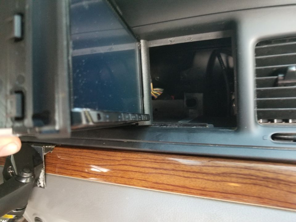 Because Ford didn't actually follow the DDIN specs on these radios, the bezel plastic has to be trimmed to fit an aftermarket DDIN chassis.