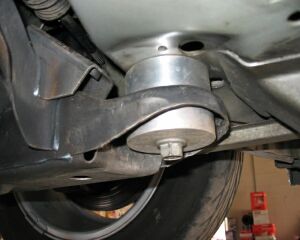 1993 Ford Taurus - Close-up of a vehicle's undercarriage, focusing on a suspension component and hardware.