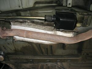 1993 Ford Taurus - Close-up view of the underside of a vehicle, focusing on the exhaust system and related components.