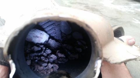 1985 Ford Bronco - The interior of a catalytic converter has broken apart, with chunks of the honeycomb structure and debris filling the chamber. The outer ca…