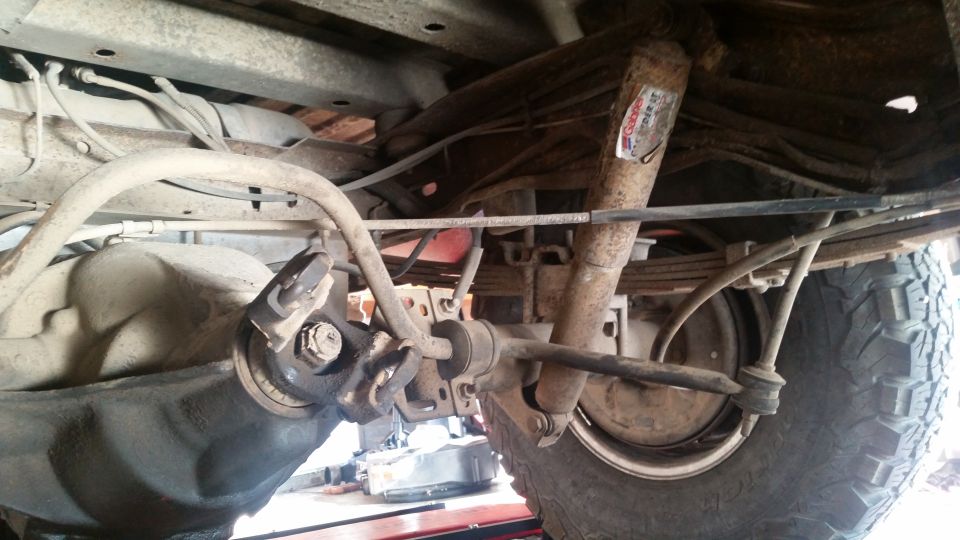 Rear suspension of a vehicle, showing differential, shocks, leaf springs, and sway bar.