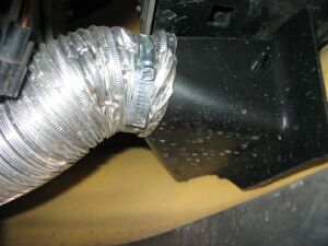 1993 Ford Taurus - A close-up shows flexible ductwork connected to a black housing, with a website logo in the corner.
