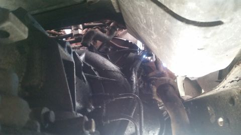 1985 Ford Bronco - Close-up of the undercarriage, showing mechanical parts of a vehicle.