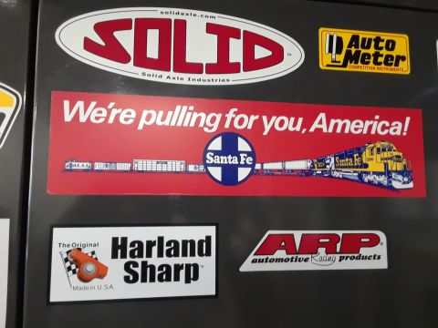 1994 Ford Bronco - A variety of automotive-themed stickers are displayed on a dark surface, brands like Solid Axle, Auto Meter, and ARP.