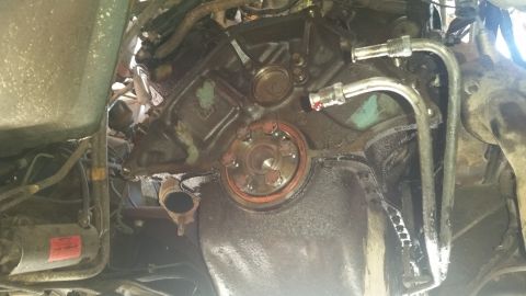 1985 Ford Bronco - Close-up view of an engine block, oil pan, and starter motor, with associated tubing.