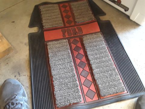 1985 Ford Bronco - These Ford-branded floor mats feature a distinctive red insert with a diamond pattern and textured gray carpet sections.