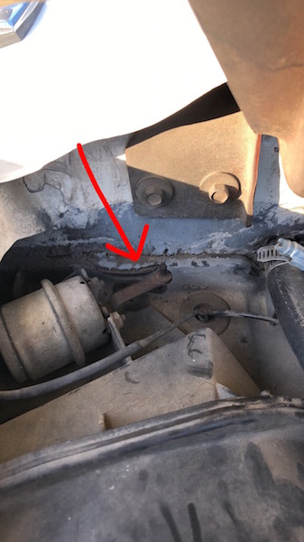 1981 Ford Bronco - A red arrow highlights a specific part within the engine compartment of a vehicle.