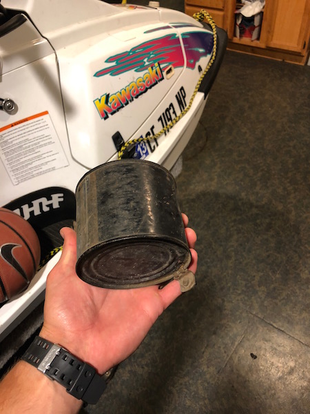 1981 Ford Bronco - A jet ski with prominent Kawasaki branding is visible, along with a basketball and a hand holding a metal can.