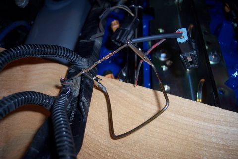 1995 Ford Bronco - Automotive wiring harness repair with alligator clips holding exposed wires.