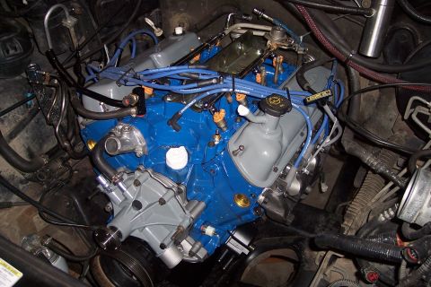 1995 Ford Bronco - Close-up view of a vehicle's engine compartment, highlighting the engine block and associated components.