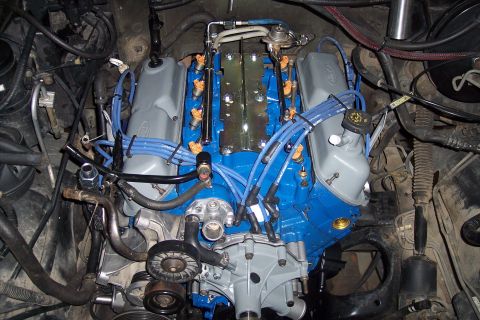 1995 Ford Bronco - The engine bay shows a Ford V8 engine with updated blue paint and wiring.