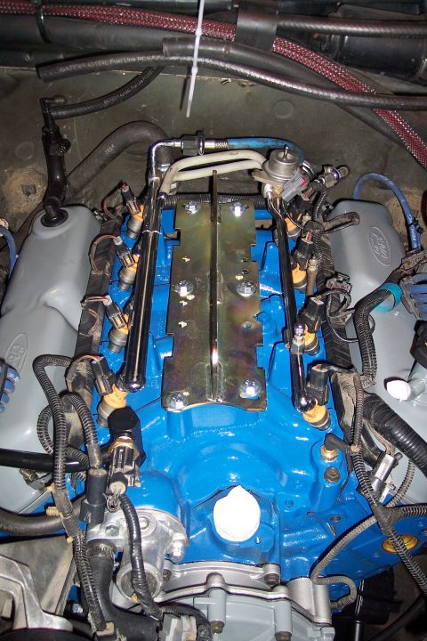 1995 Ford Bronco - Engine bay detail fuel injectors and intake manifold components.