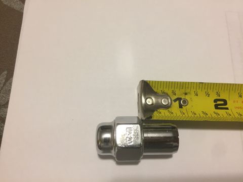 1979 Ford Bronco - Lug nut with 1/2-20 thread size measured against a tape measure.
