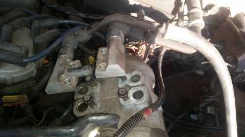 1985 Ford Bronco - Engine compartment detail showing various parts and connections.