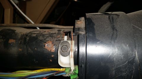 1985 Ford Bronco - Rusty metal and wiring harness detail, likely part of a vehicle's steering column assembly.