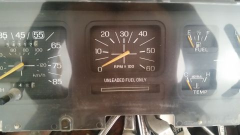 1985 Ford Bronco - Dashboard gauges from a 1985 Ford Bronco, including speedometer, tachometer, fuel, and temperature indicators.