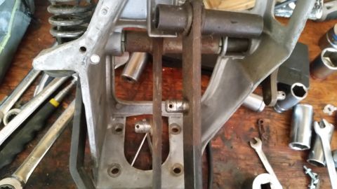 1985 Ford Bronco - Automotive part and tools laid out on a workbench, likely for repair or modification.