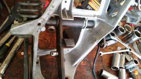 1985 Ford Bronco - This image shows a vehicle's transmission part surrounded by various tools, suggesting a repair or modification process.