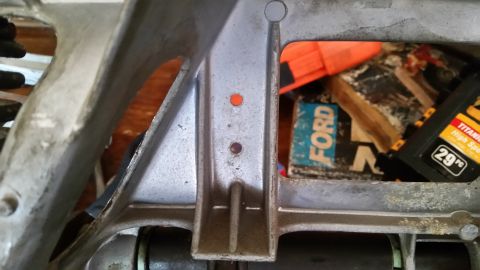 1985 Ford Bronco - A close-up view of a vehicle's frame part, with a box labeled 'FORD' and a Supermotors logo visible in the background.