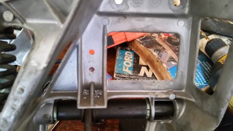 1985 Ford Bronco - A vehicle part is shown with a book inside, partially obscuring the view of the component.